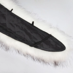 Detail showing white faux fur texture with black quilted lining and elastic loops