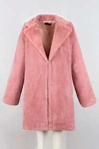 Close-up of the plush pink faux fur texture and brand label on a long winter coat