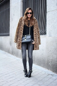 Chic leopard print faux fur coat styled with black leather boots and a shoulder bag