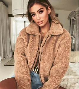 Detail shot of the plush teddy fleece texture and zip collar on this camel short jacket