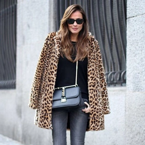 Detail of leopard print faux fur coat with notch lapel and trendy street style design