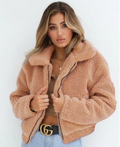 Detail shot of camel fleece jacket featuring wide lapels and a warm fuzzy texture