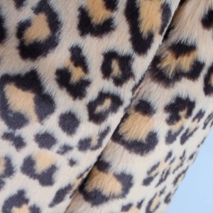 Detailed close-up showing soft leopard print faux fur texture with high-quality fibers