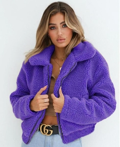 Close-up of premium purple teddy fur jacket texture with dark metal zipper and stand collar