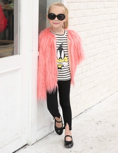Detail of pink faux fur vest paired with black and white striped cartoon duck t-shirt