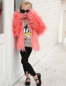 Detail shot of girls' pink faux fur coat with soft texture and long hair stylish finish