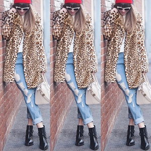 Chic women's leopard print faux fur coat paired with denim jeans and red beanie