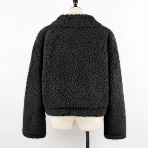 Rear view of black cropped faux shearling jacket with soft fleece texture on mannequin