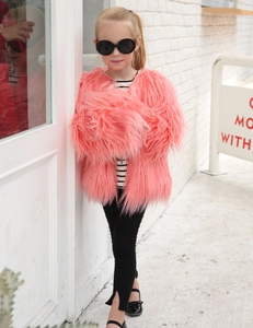 Detail of pink faux fur coat for girls with long plush texture for stylish winter fashion