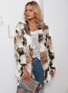 Detail of multi-color faux fur coat featuring geometric patterns and plush texture