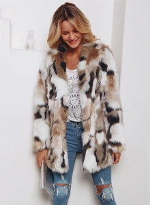 Detailed texture view of a multicolored faux fur coat styled with a white graphic tee