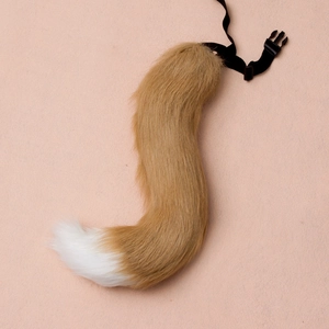 Detail of faux fur animal tail with adjustable buckle strap for cosplay and costumes