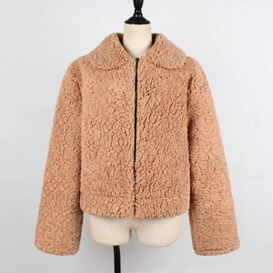 Detail of warm faux shearling camel jacket featuring a fuzzy collar and zipper closure