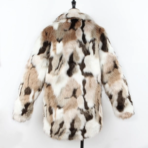 Detailed close-up of textured faux fur coat with beige, brown, and black abstract pattern