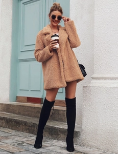 Street style view of mid-length brown teddy coat with warm fleece texture and notch lapels