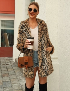 Street style view of long leopard faux fur coat with notched collar and plush texture