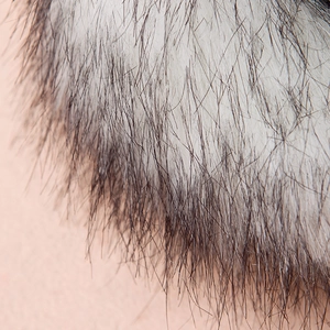 Close-up of white and grey faux fox fur texture showing fine, dense long fibers clearly
