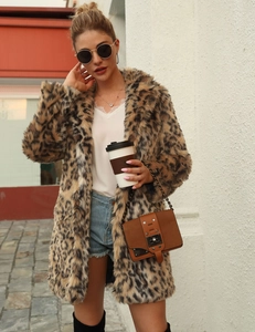Detailed texture of leopard print faux fur coat with silver chain suede crossbody bag
