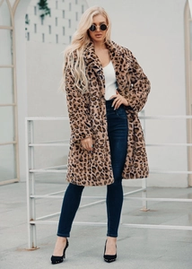 Close-up of faux fur texture and leopard print pattern on long winter coat