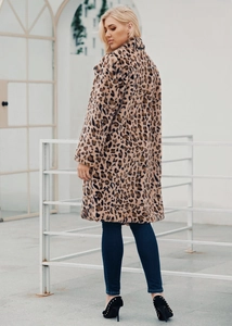 Outdoor street view showing the back cut and knee-length of long leopard faux fur coat