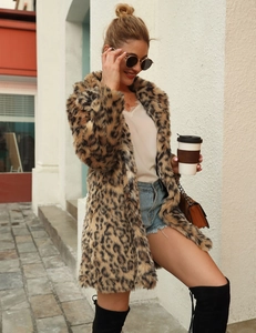 Outdoor street style shot of a long faux fur leopard print coat with a lapel collar