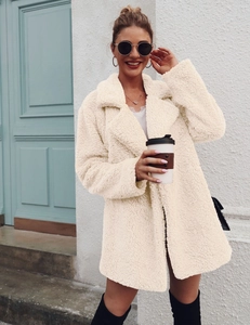 Close-up of cream faux shearling teddy jacket with lapel collar and soft texture