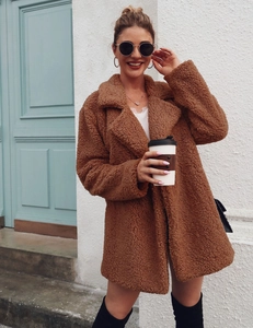 Street style shot of a brown teddy fleece jacket with lapel collar and soft texture