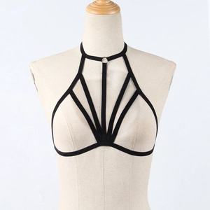 Detail of black elastic body harness with metal rings and geometric strappy design