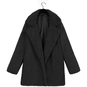 Detail of black teddy coat featuring textured wool-like fabric and smooth satin lining