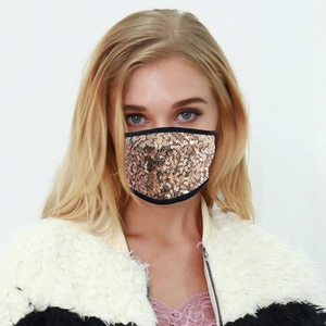Fashionable champagne gold sequin face mask with black fabric trim and ear loops