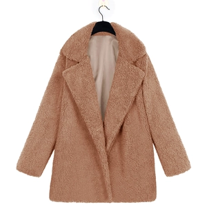 Detail of camel faux fur jacket showing the plush texture and tailored notched lapel