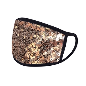Detailed view of champagne gold sequin party mask with black fabric trim and ear loops