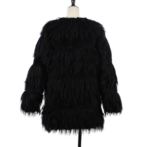 Détail de la texture en fausse fourrure noire sur un manteau long pour femmes