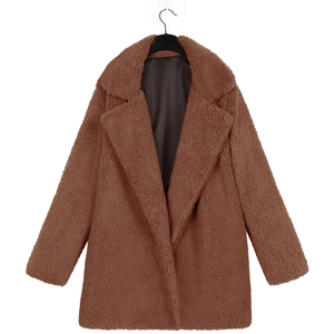 Detailed macro view of plush teddy faux fur texture and lapel of the brown autumn coat