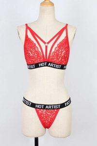 Detail of red floral lace lingerie set with HOT ARTIST lettered straps and metal rings