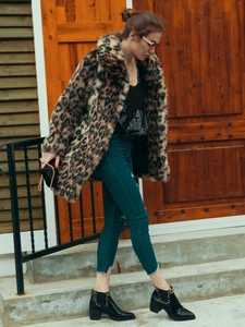 Detailed texture of leopard print faux fur coat with lapel collar and soft thick material