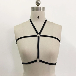 Close-up of black elastic harness bra with silver metal rings on a mannequin