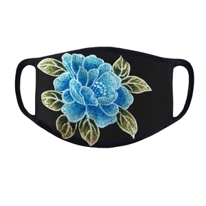 Close-up detail of blue floral embroidery on breathable black fabric sun protection mask