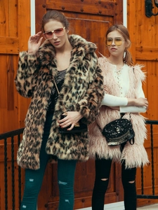 Outdoor street style view of high-fashion leopard faux fur coat and pink plush vest outfits