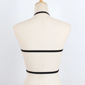 Detail view of a black elastic strappy body harness on a female mannequin back