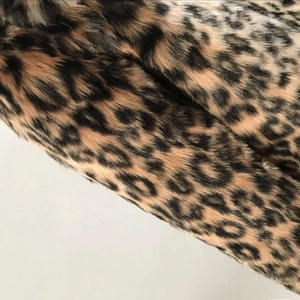 Detailed macro view showing the soft texture and thick pile of leopard print faux fur fabric