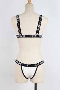 Detail of white lingerie set featuring black elastic bands with HOT ARTIST lettering