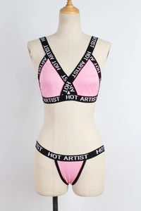 Close-up of pink sexy lingerie set with black elastic HOT ARTIST letter printed straps