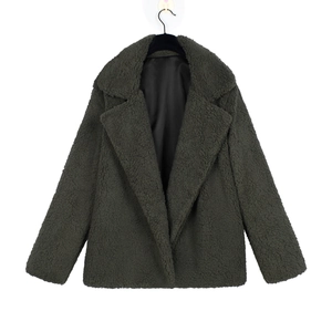 Detail of dark green teddy coat featuring a notch lapel and warm faux shearling texture