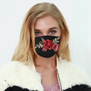 Detailed close-up of a breathable black face mask featuring a red rose floral embroidery