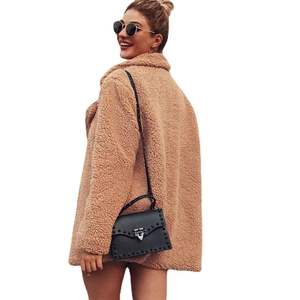 Women's autumn camel teddy coat with lapel collar and stylish black studded crossbody bag