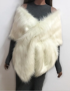 Detail shot of white faux fur shawl showing plush texture and criss-cross style design