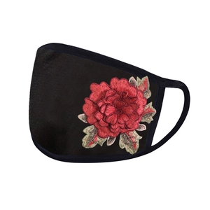 Detailed close-up of vibrant red floral embroidery on a black breathable sun protection mask