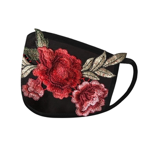 Close-up of elegant red rose embroidery on a breathable black fabric sun protection mask