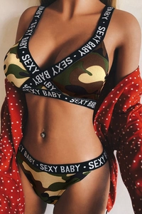Detailed view of camouflage lingerie set with 'SEXY BABY' lettered webbing and cross straps